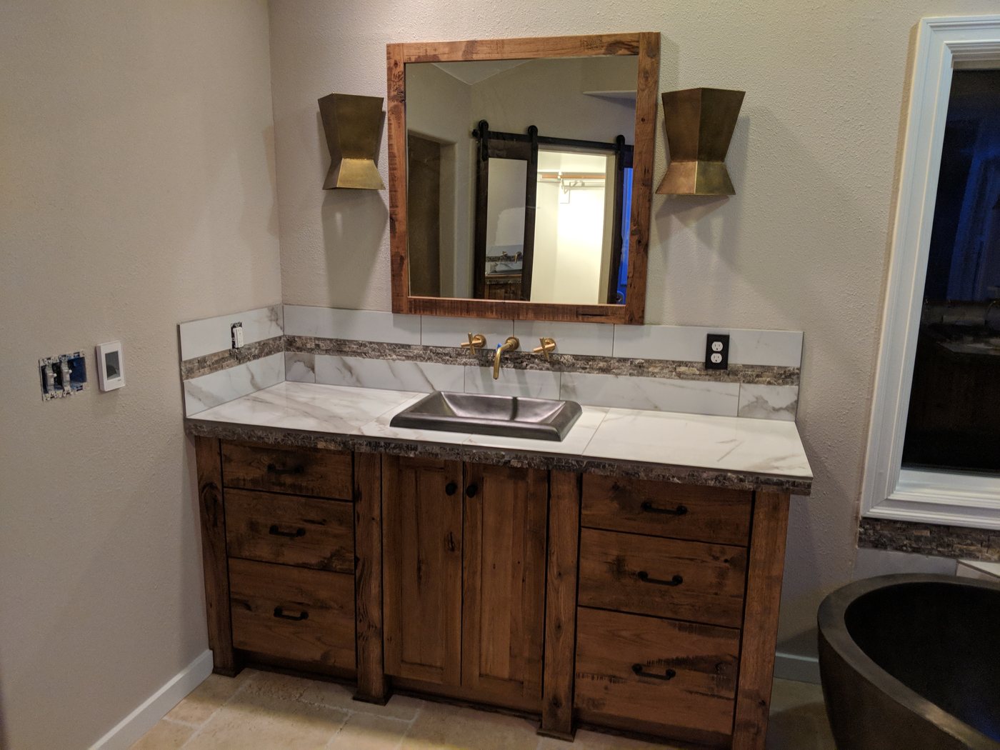 Rustic custom wooden bathroom vanity with marble countertop