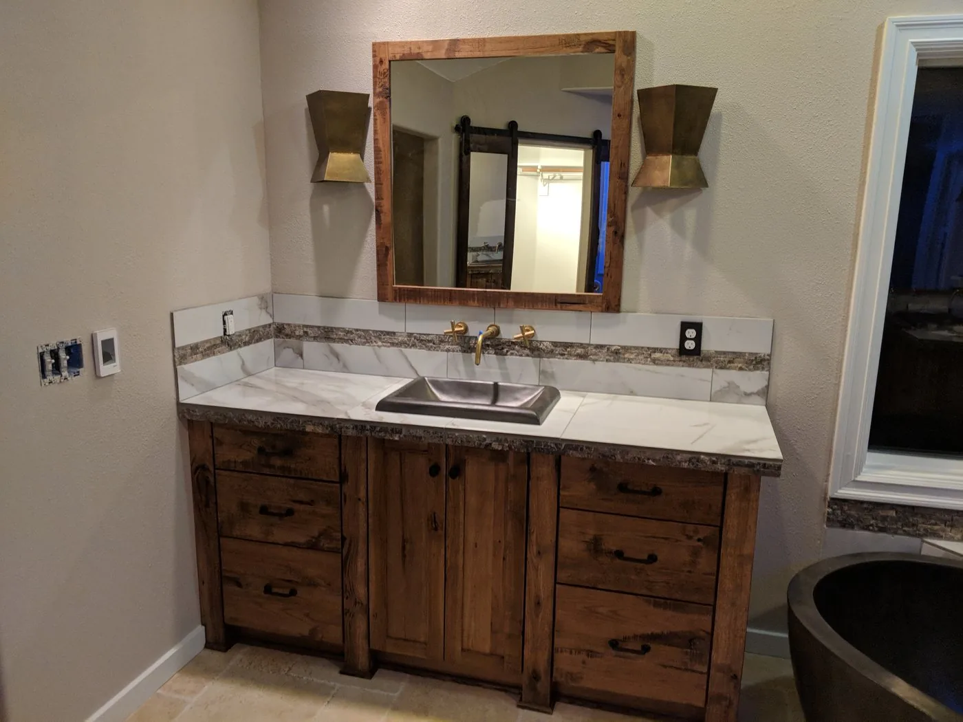 Rustic custom wooden bathroom vanity with marble countertop