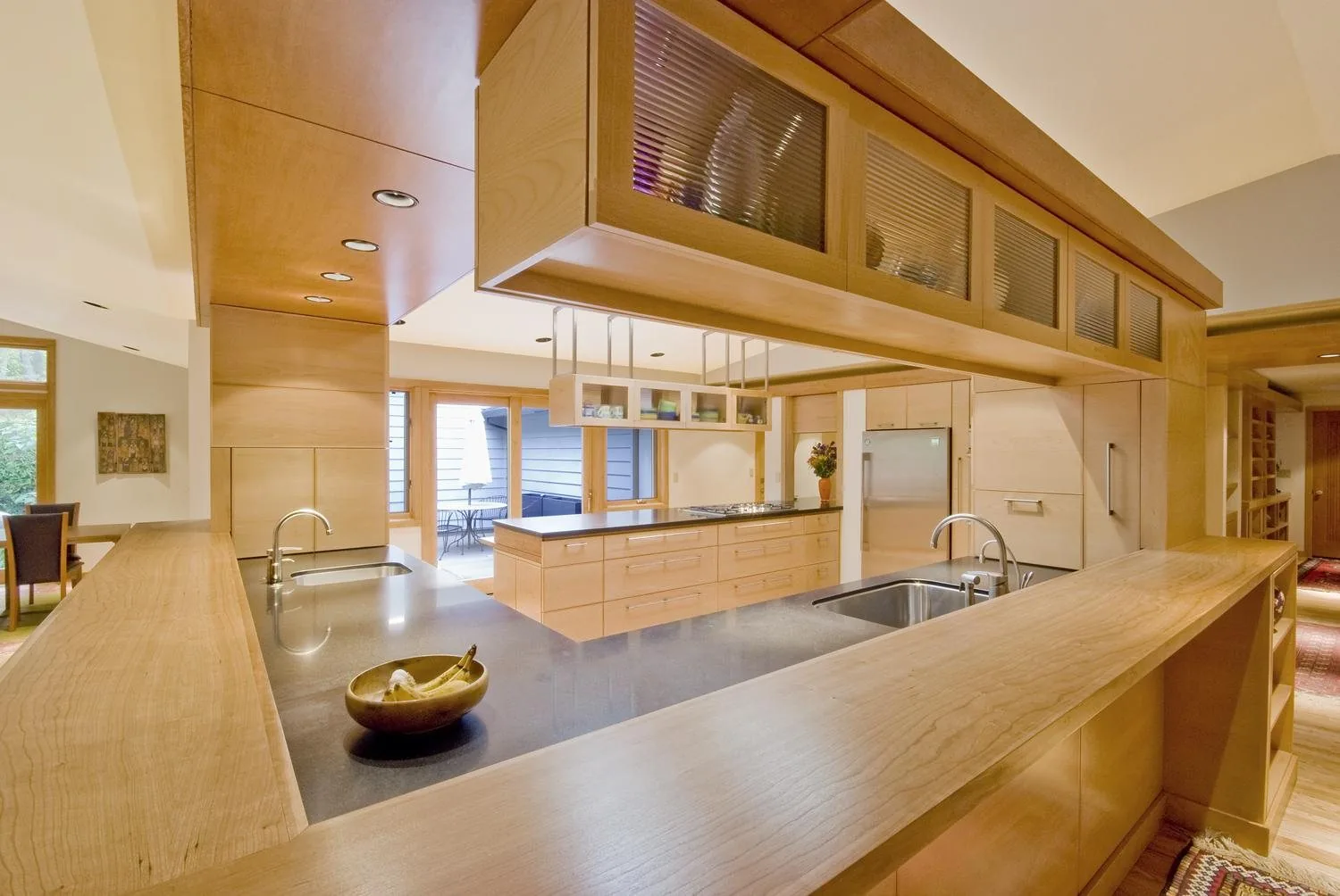 Modern kitchen with extensive custom wood cabinetry by KDJ Cabinet Design