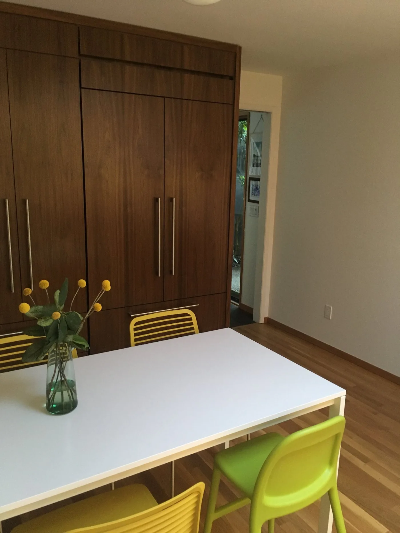 Dining space with full-height custom wooden cabinets by KDJ